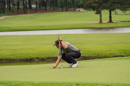 Matthew Javier lining up a putt