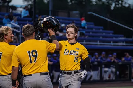 Drey Barrett is welcomed back to home plate after his home run