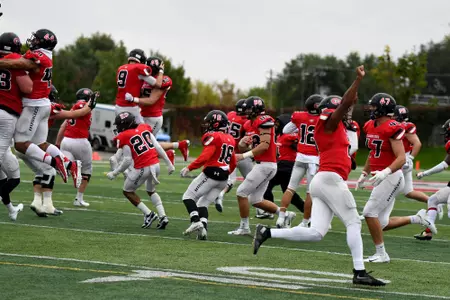 Huskies celebrating after a big overtime win over Concordia-St. Paul