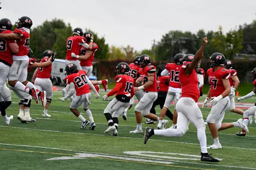 Huskies celebrating after a big overtime win over Concordia-St. Paul