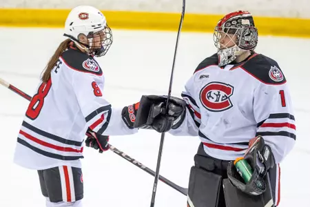 Sanni Ahola and Grace Wolfe fist bump vs. St. Thomas 1-31-25
