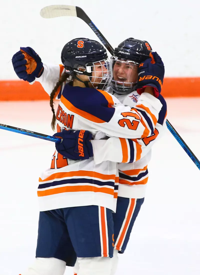 Mae Batherson, left, celebrates with Emma Polaski.