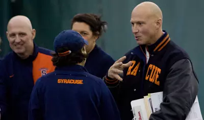 Head coach Luke Jensen instructs junior Chelsea Jones.