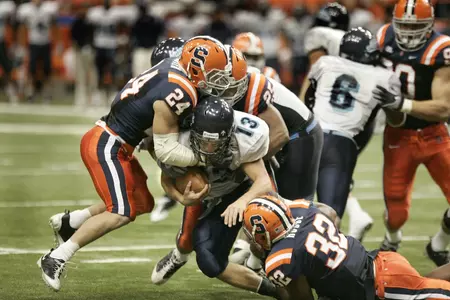 Max Suter and Doug Hogue make a tackle