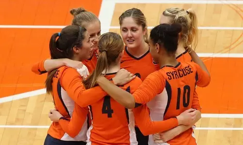 The team gathers on the court.