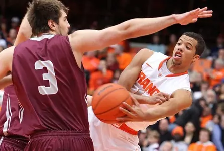 Michael Carter-Williams dishes off from under the net.