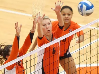 Nicolette Serratore, Monika Salkute, & Silvi Uattara defend at the net.