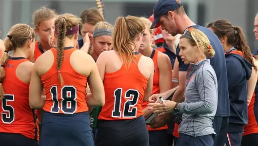 Coach Ange Bradley talks with Emma Russell (12) and the team during a time out on the field.