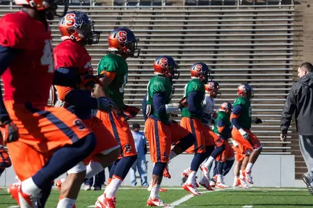 The SU football team does warm up drills before practice.