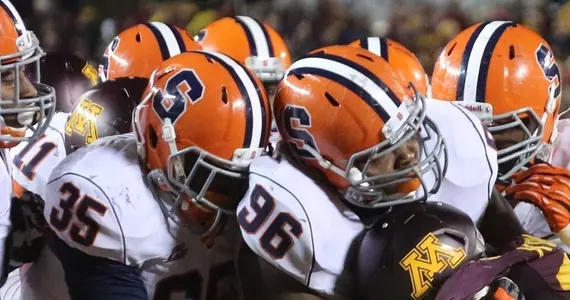 The SU defense swarms a Minnesota ball carrier.