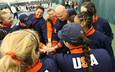 The squad gathers before the start of play.