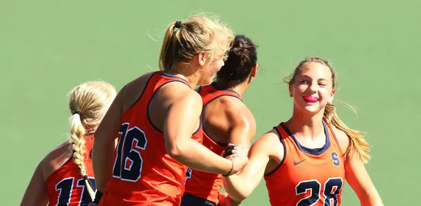 Erin Gillingham (28) congratulates Roos Weers on her score.