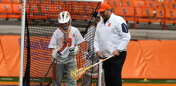 Regy Thorpe gives final instructions to Allie Murray before the Orange take on Loyola.