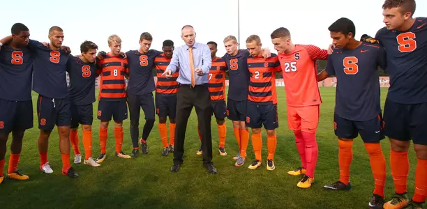 Coach McIntyre gives final instructions to the Orange.