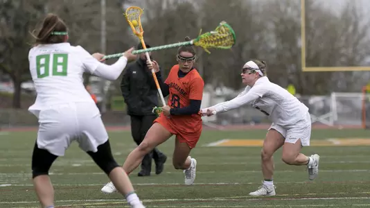 Neena Merola splits two Oregon defenders.