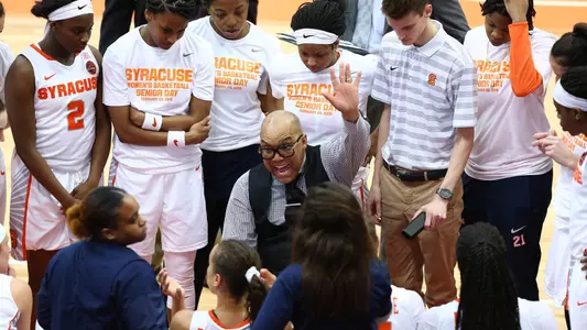 Coach Q talks to the team in a huddle against Boston College.