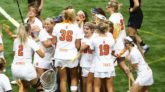The Orange celebrate their OT win against Northwestern.