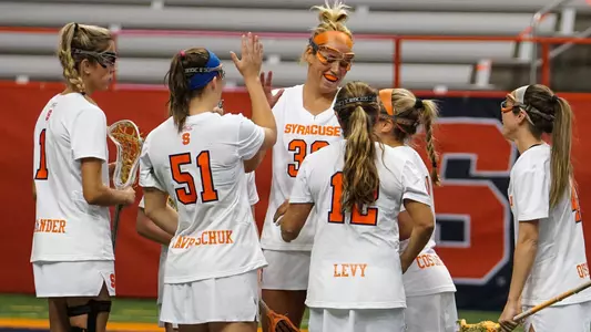 The Orange celebrate one of three goals by Julie Cross.