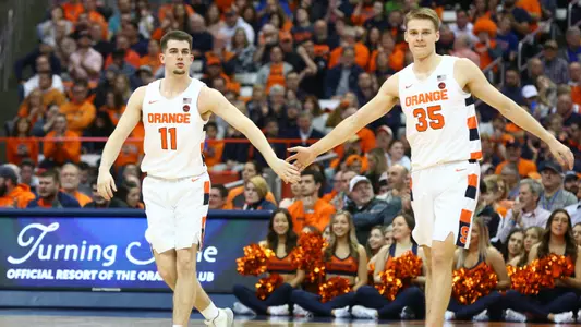 Joseph Girard III and Buddy Boeheim get ready to play defense.