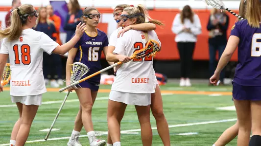 Megan Carney and Sam Swart celebrate a goal against Albany.