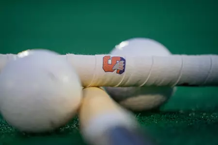 Cross Field Hockey Sticks on the turf with balls.