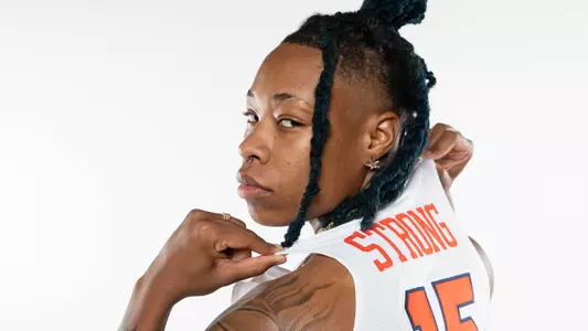 Asia Strong poses with her last name on her Syracuse jersey proudly.