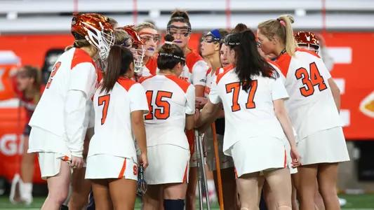 The Orange defense gets instruction from Coach Defliese.