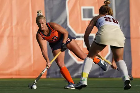Charlotte de Vries dribbles past a defender.