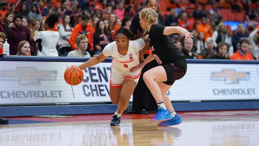 Kennedi Perkins drives past Hailey van Lith on Sunday, Jan. 29