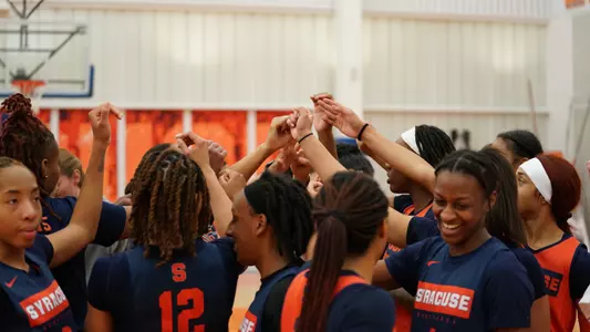 Women's basketball huddles after practice in the Carmelo Anthony Center