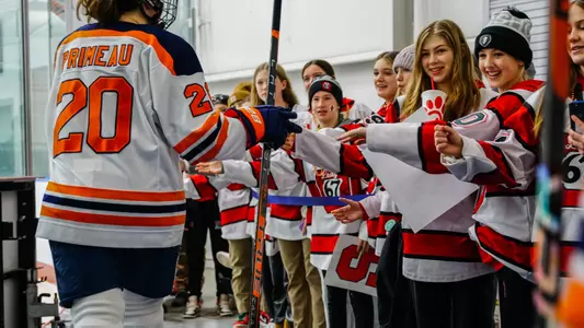 Madison Primeau high fives Kids Corner