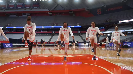 Women's basketball warms up during WNIT game.