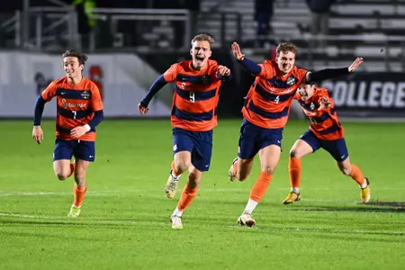 Players celebrate after the game-winning PK goes in to secure Syracuse's first NCAA Championship.
