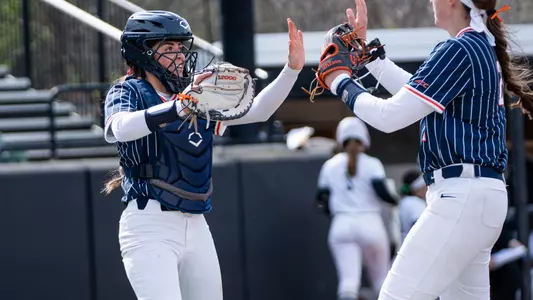 Laila Alves and Madison Knight celebrate a strikeout against Binghamton