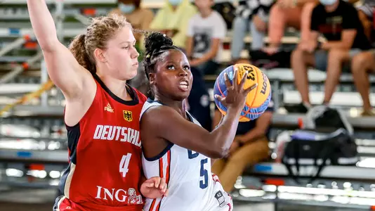 Woman, Alexis Peterson, in USA uniform shooting playing basketball against Dutch woman.