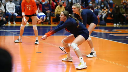 Polina Shemanova receives a serve wearing a navy blue Syracuse uniform.