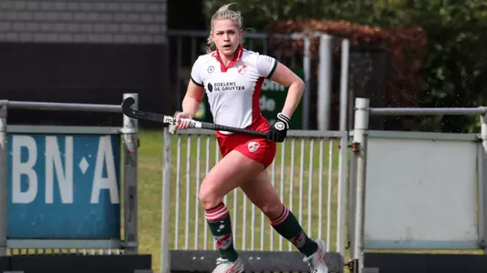 Pieke van de Pas running down field, stick at hip level awaiting a pass from a teammate.