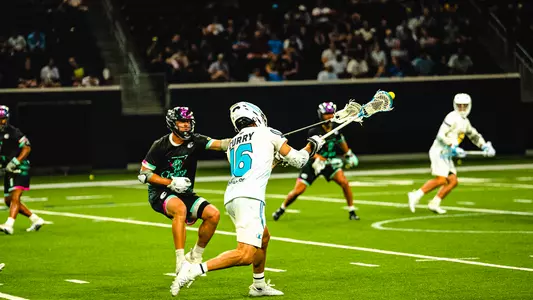Brendan Curry, wearing an all-white Atlas LC uniform, rips a shot against Chrome LC.