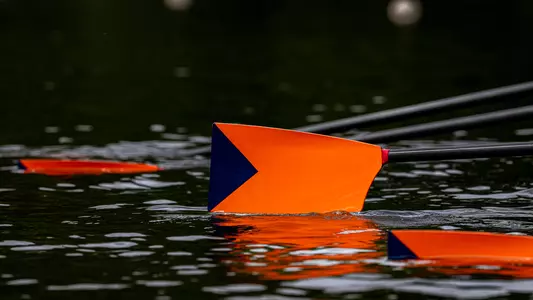 Syracuse University rowing oar with orange and navy blue blade.