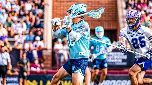 Brendan Curry takes a left-handed shot against the Waterdogs, wearing a powder blue throwback porthole jersey.