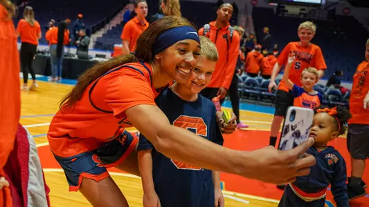 Alaina Rice takes a photo with a fan at Monroe Madness 2022