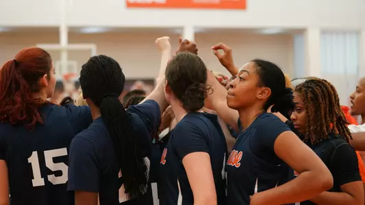 Women's basketball players huddle