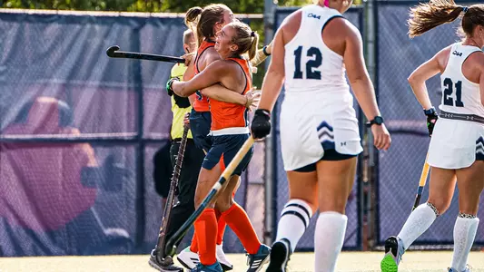 Syracuse field hockey players Olivia Bell and Hattie Madden celebrate a 'Cuse goal
