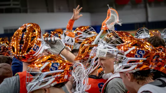 Men's lacrosse huddle at Ensley