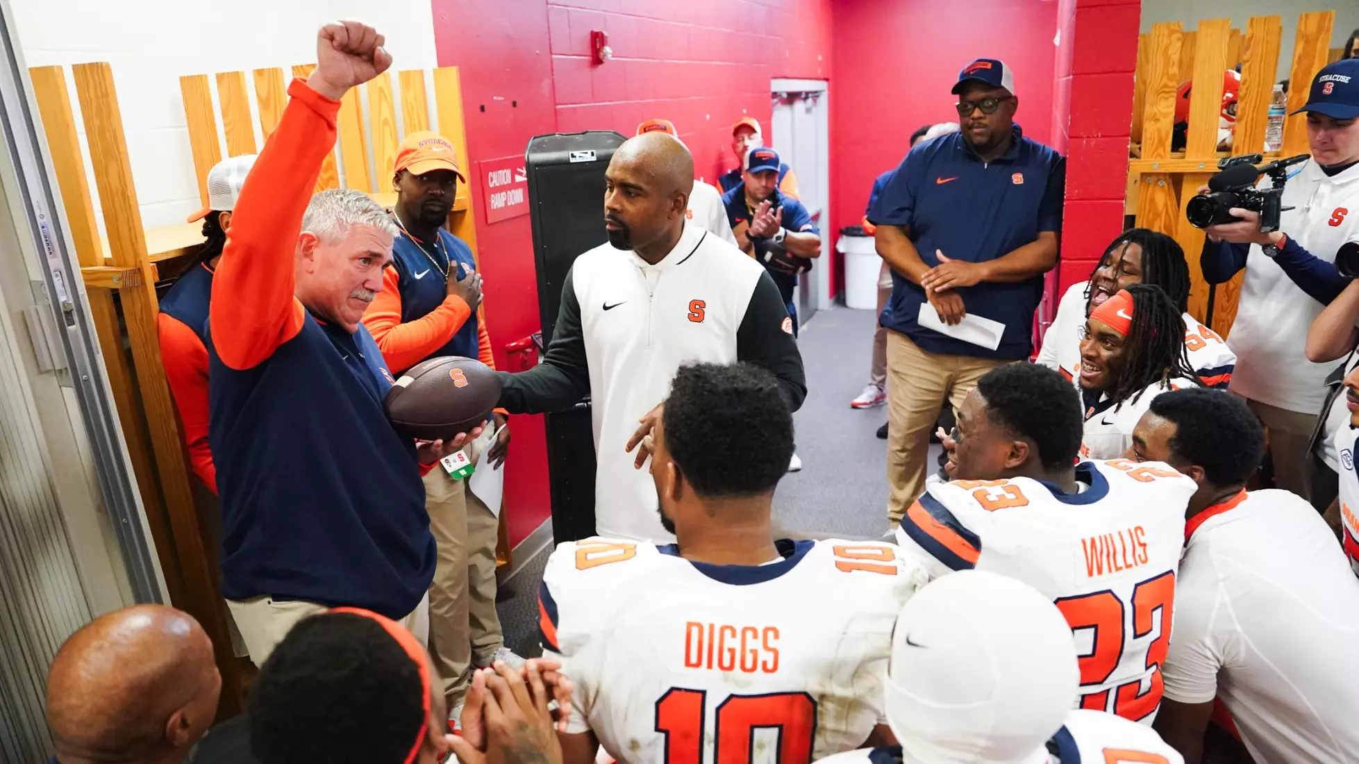 Coach Will Hicks gets the game ball from head coach Fran Brown