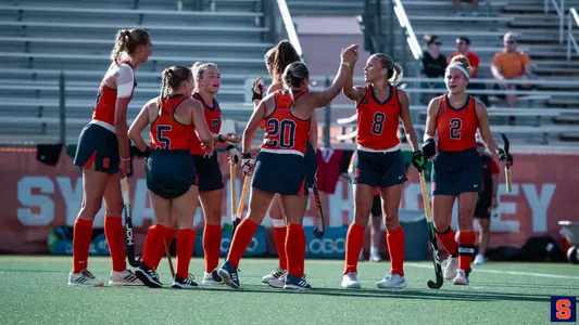 Field hockey celebrates a goal at JS Coyne Stadium