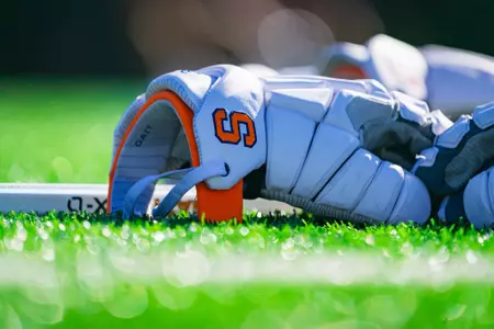 Men's lacrosse gloves on turf at practice
