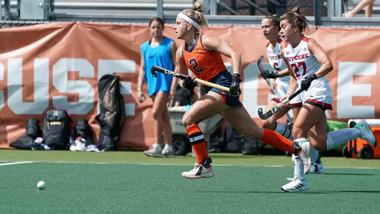 Berber Bakermans runs down the field hockey away from defenders