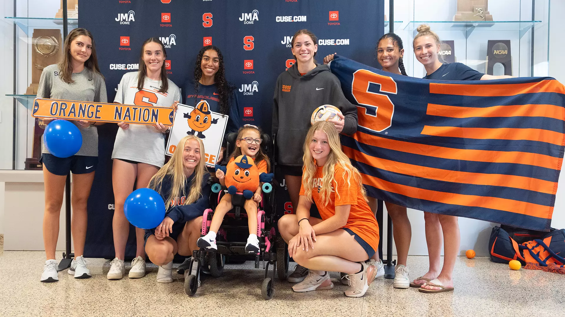 More Syracuse soccer players and the Syracuse flag join Lilianna to celebrate her signing!