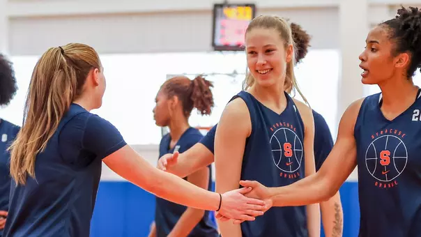 WBB high fives at practice